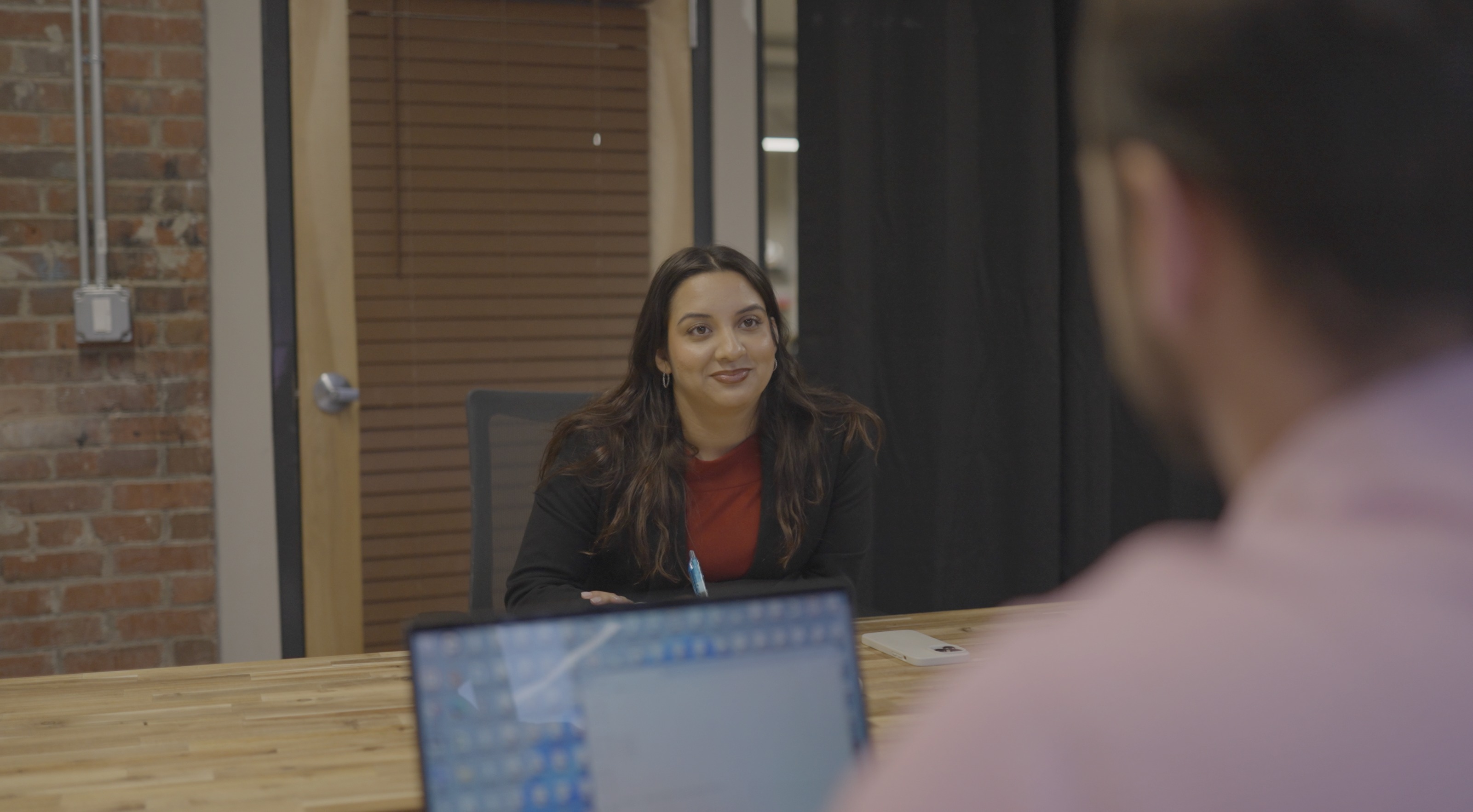 An Armada Law team member working at a wooden desk