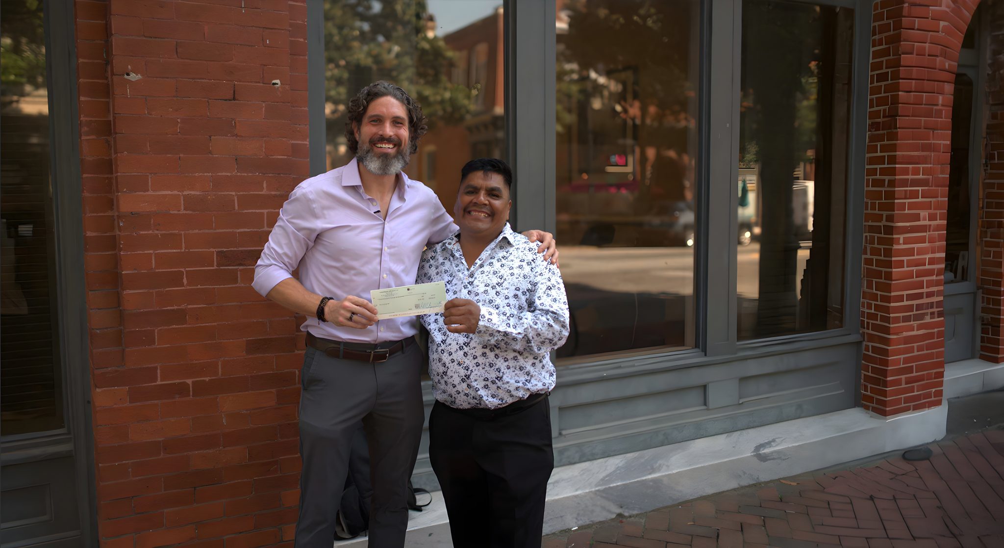 Armada Law attorney handing a client a settlement check