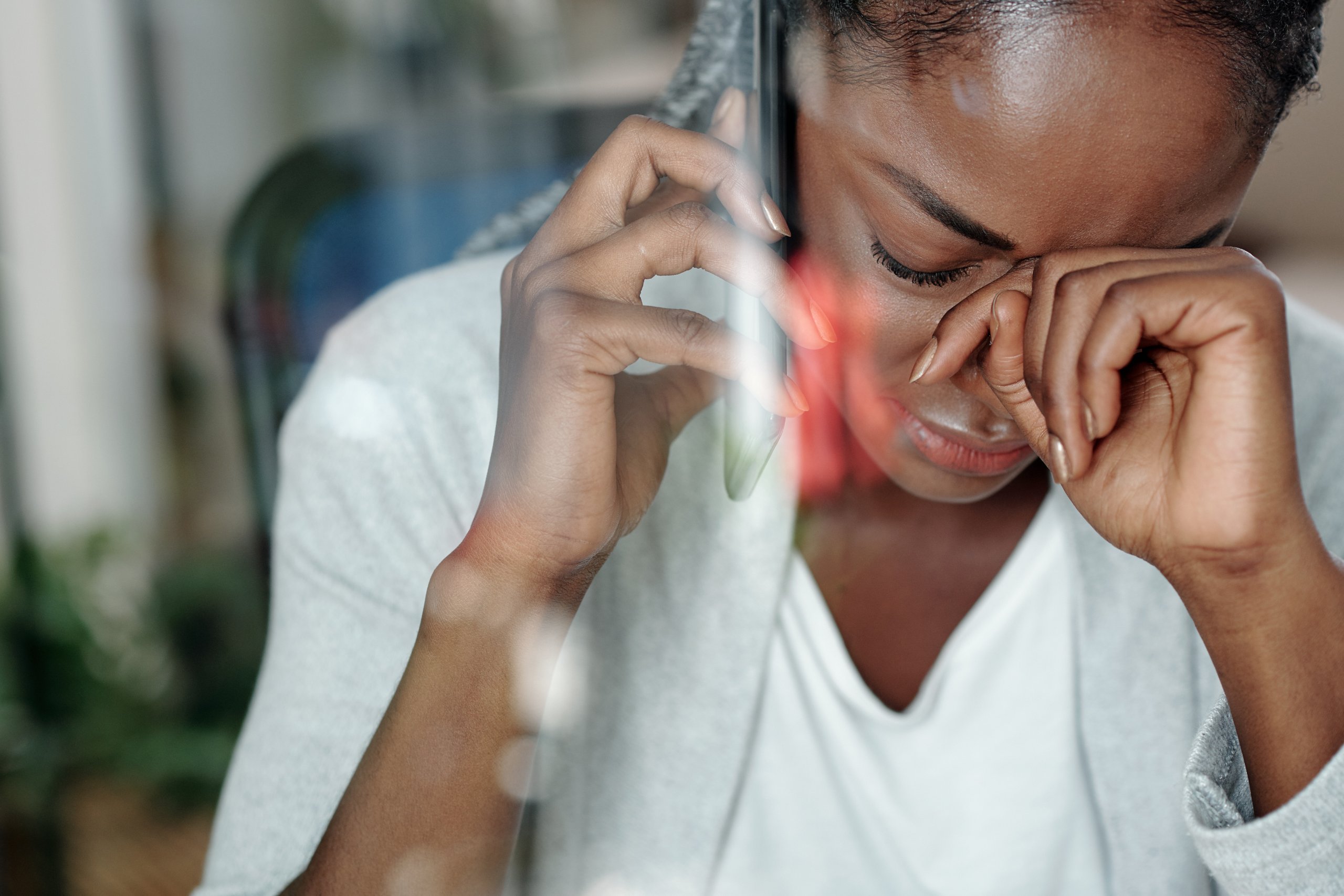 A person looks down while touching a phone.