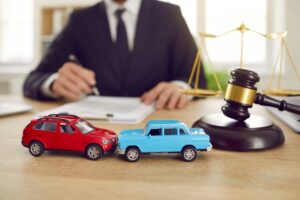 Car accident lawyer sitting at a desk signing documents