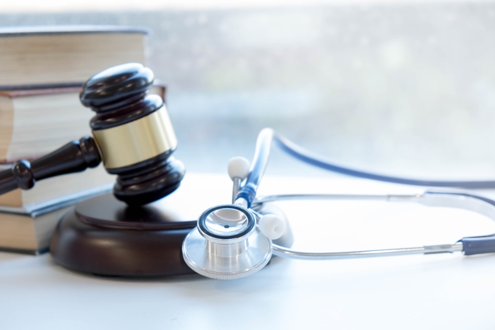 A stethoscope and a gavel on a table